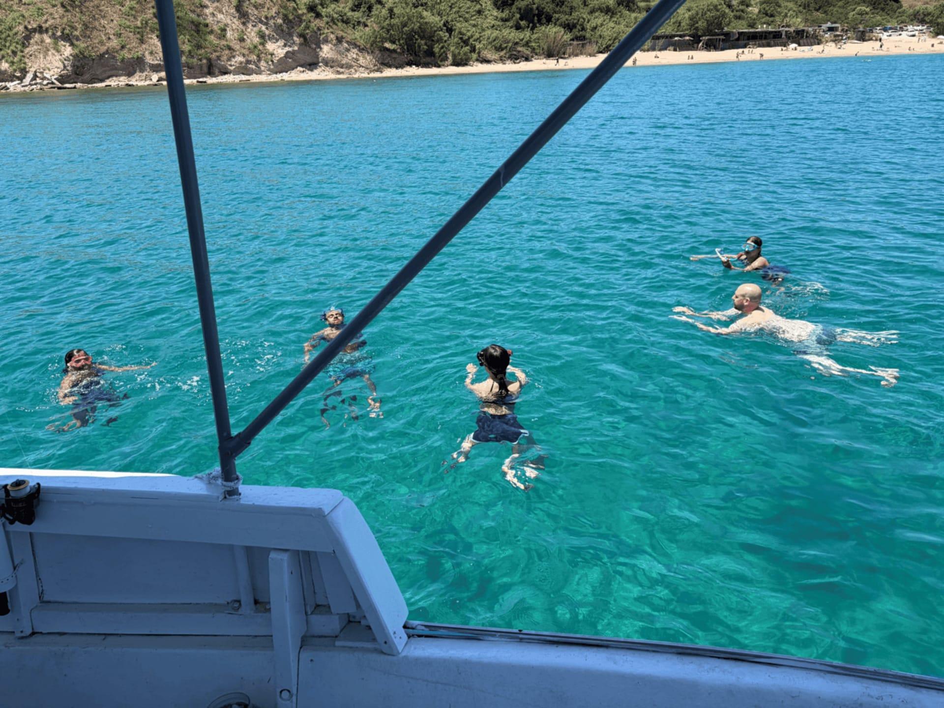 Guests swimming in crystal-clear Aegean water
